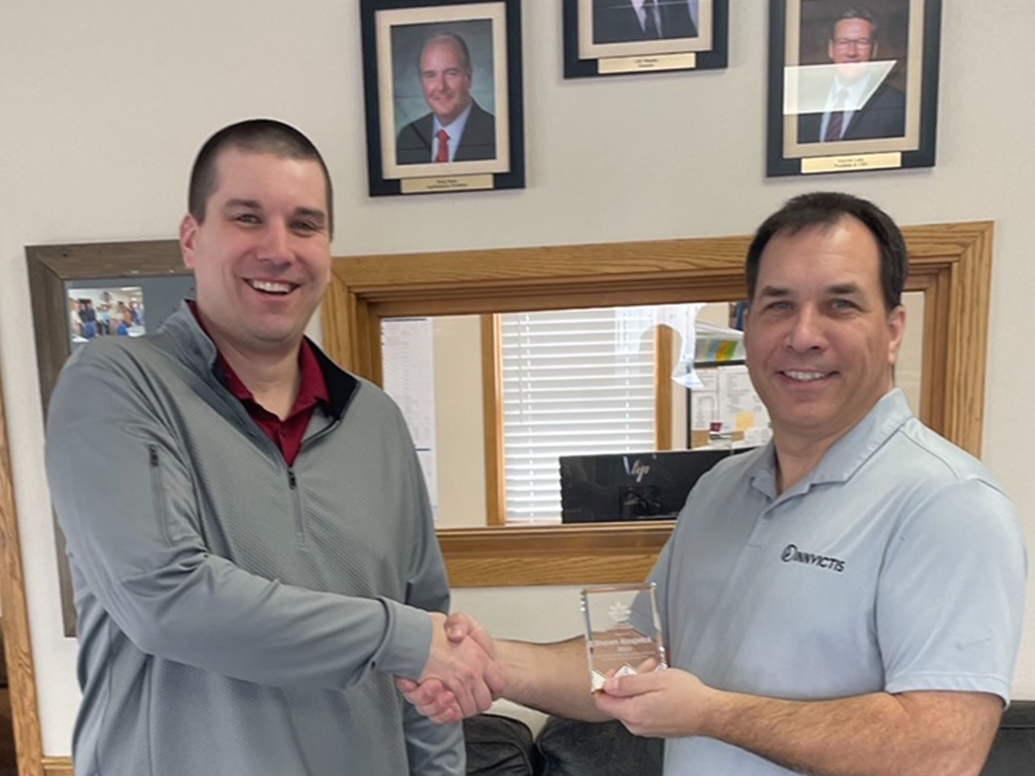 John Christianson, ND CCA Board Chair on left, presents Shawn Kaspric, CCA, CPAg with the 2023 ND Certified Crop Adviser Award. The two are shaking hands